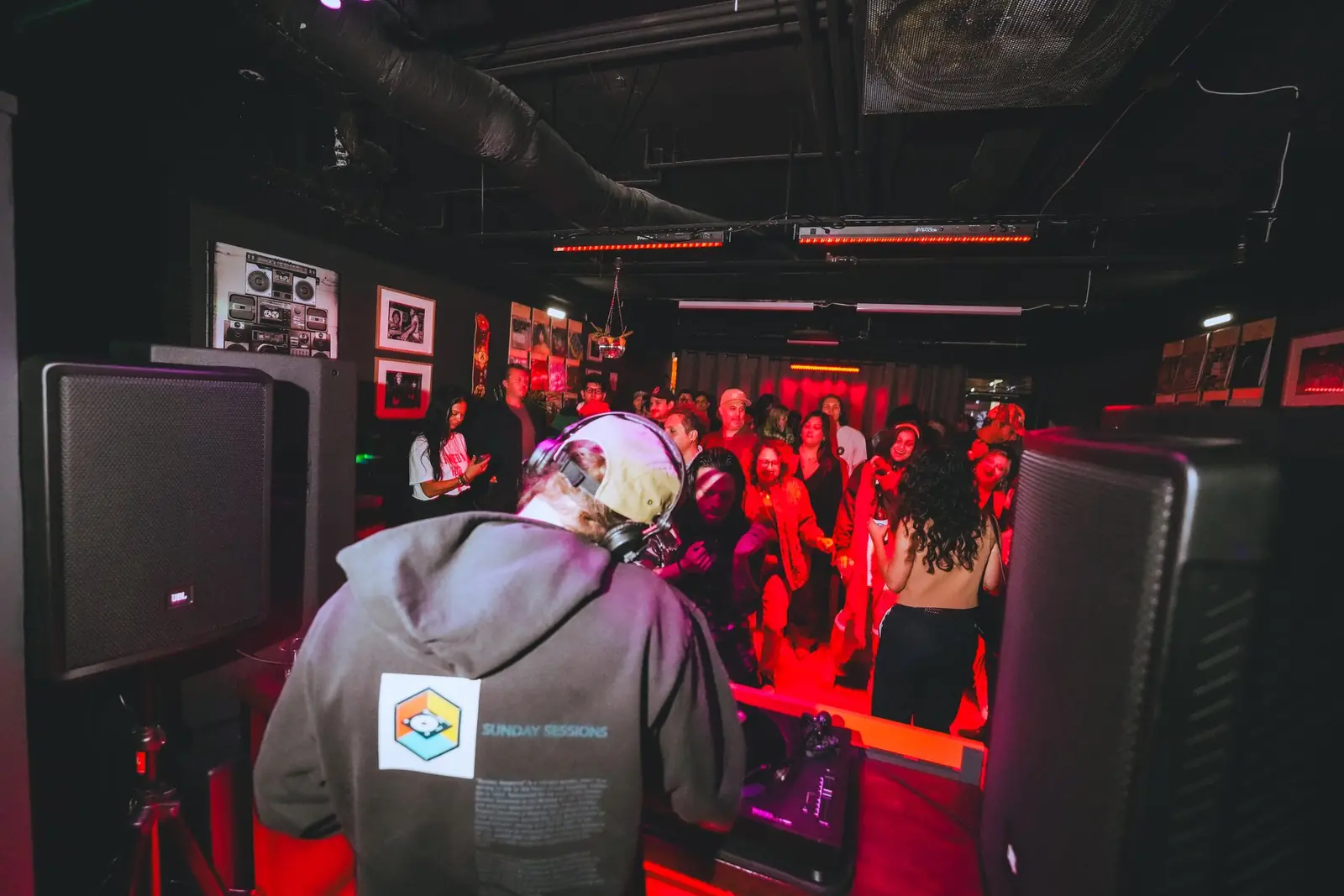 View over the DJ's shoulder to a full room