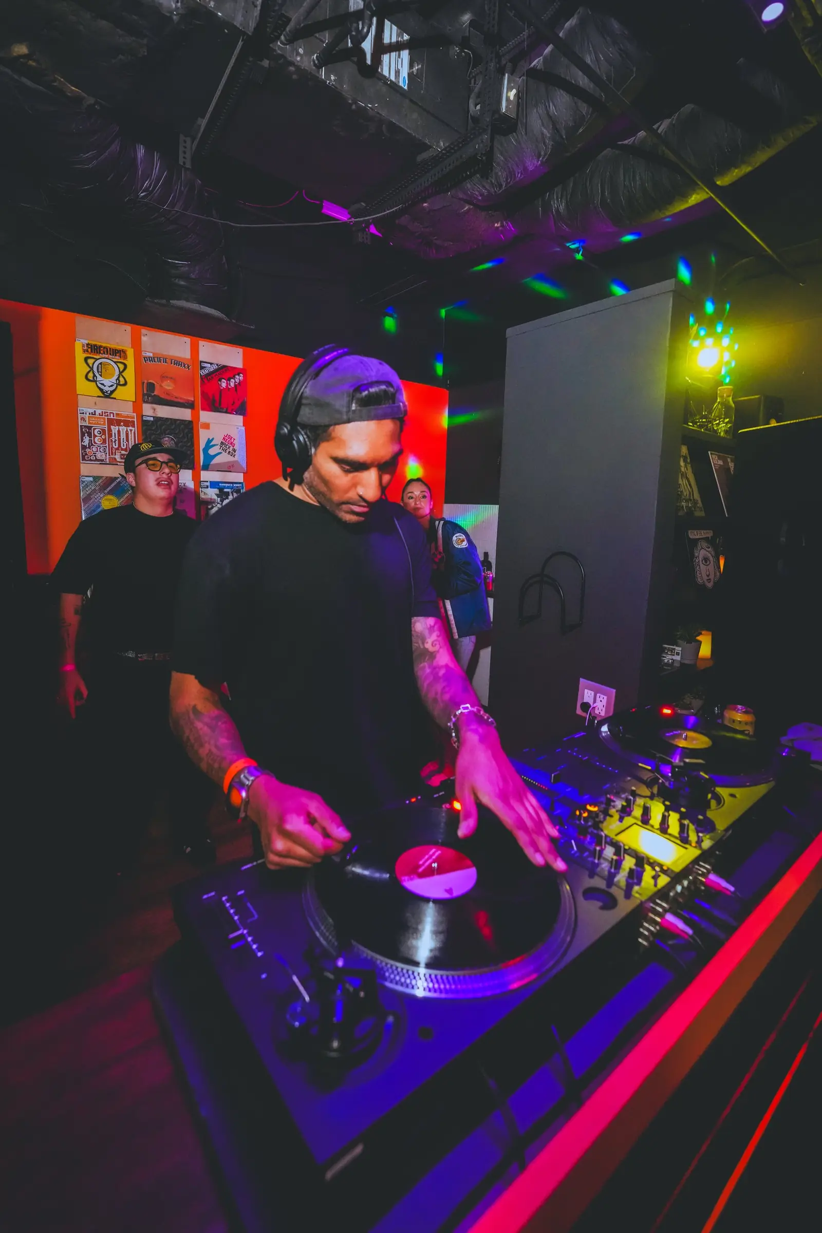 Hands cueing a record on a Technics deck