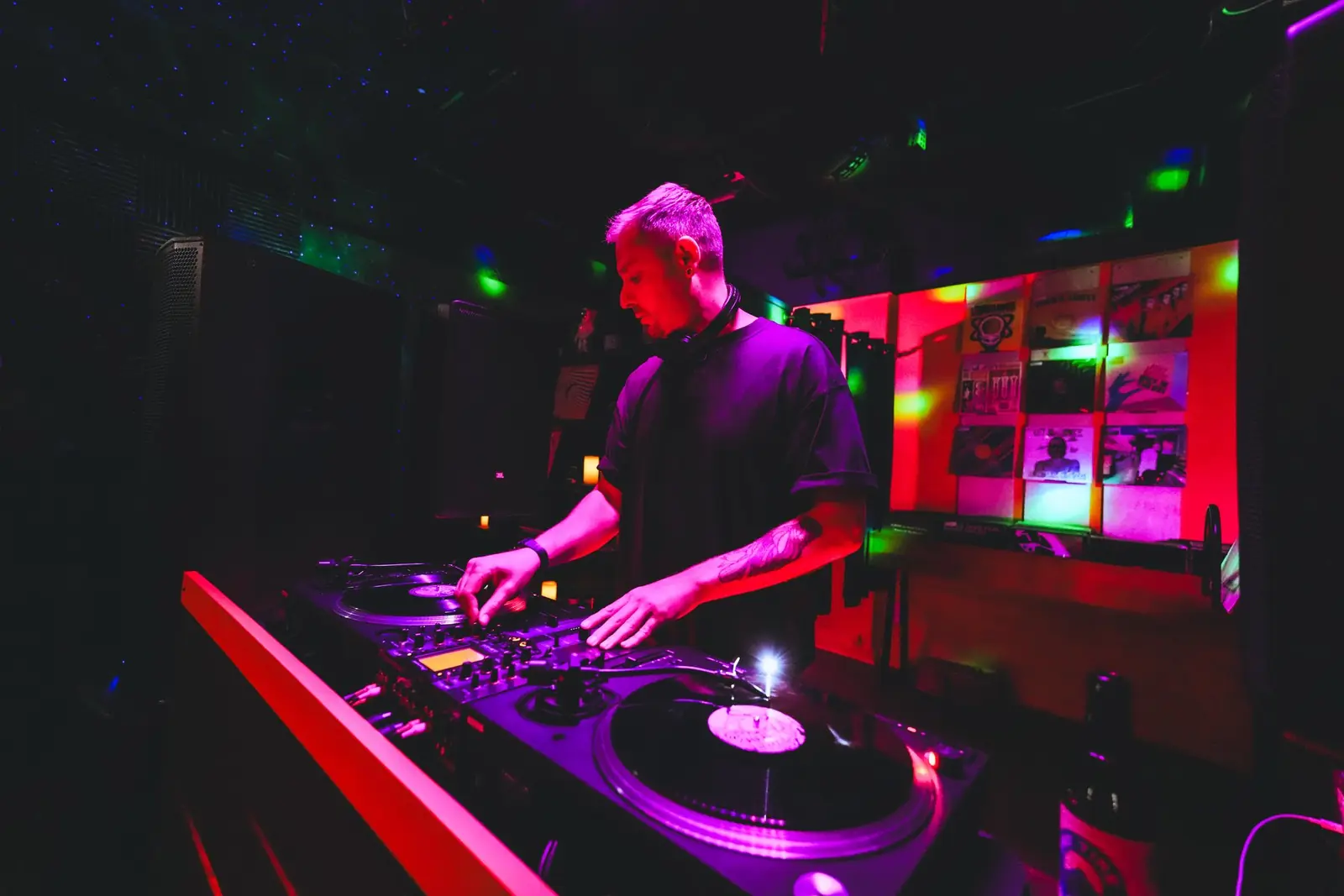 Turntables and mixer under purple light