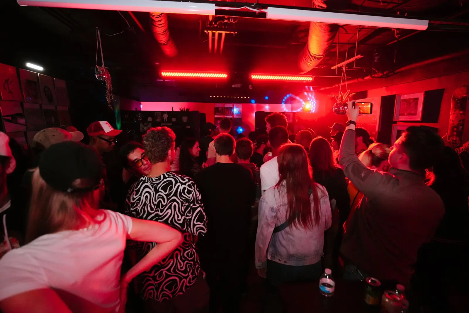 The room dancing, lit red, at a Foot Work night