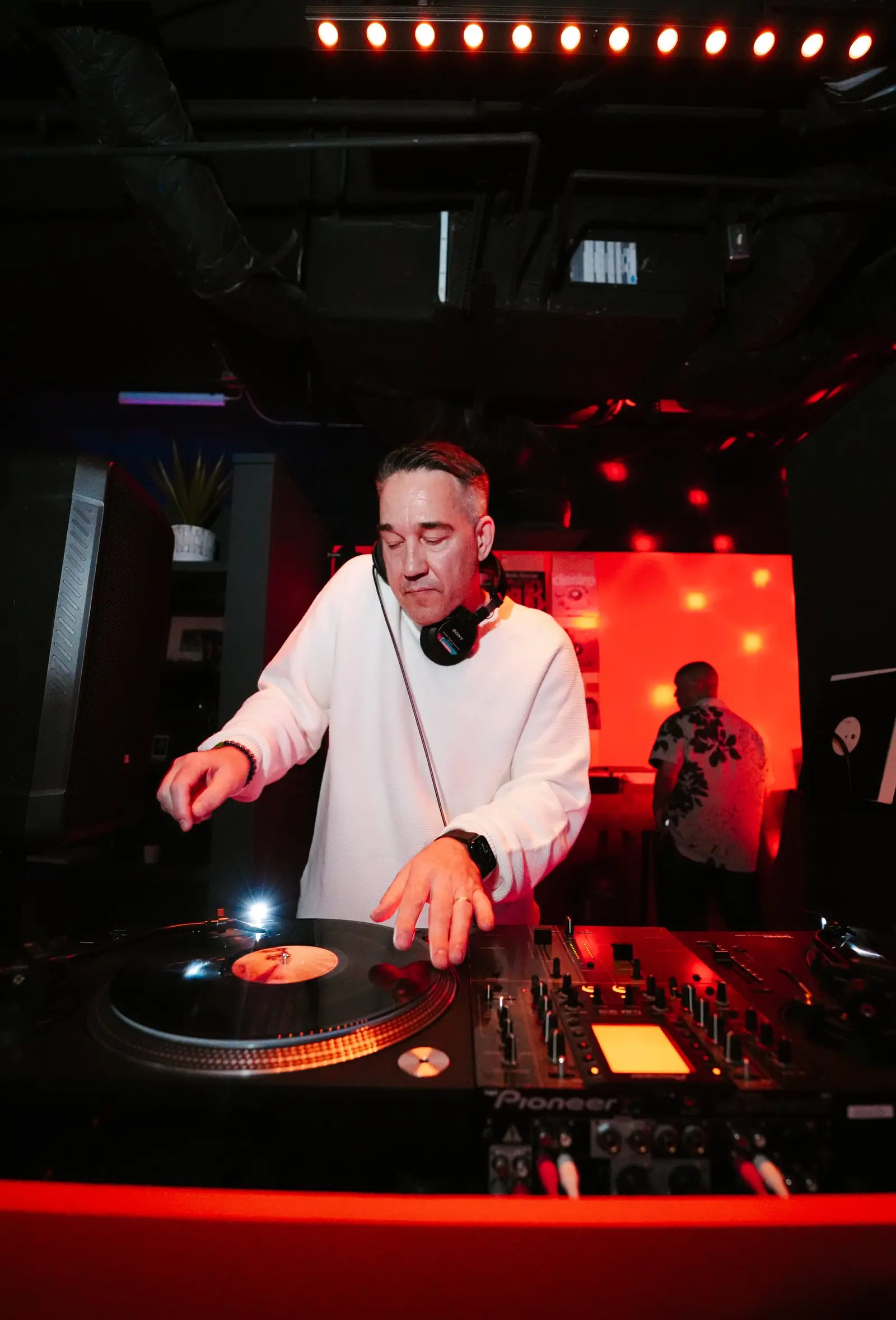 DJ mid-set on the club-standard booth